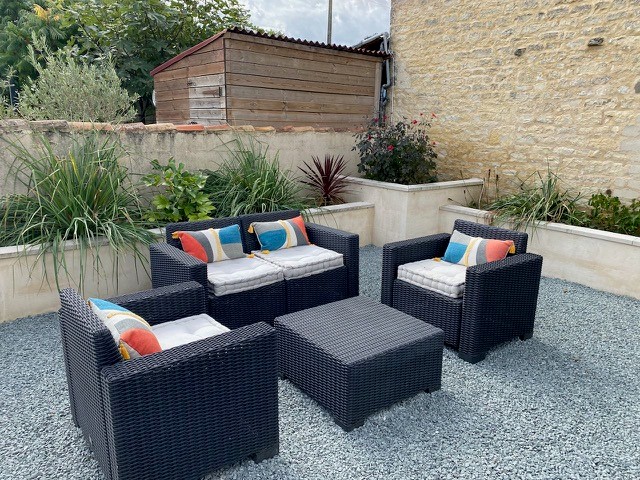 comfortable seating on gravel terrace area of Sans Soucis gites