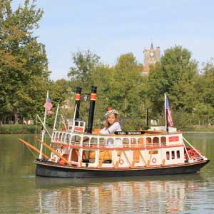 a girl sitting in a miniature boat, port miniature