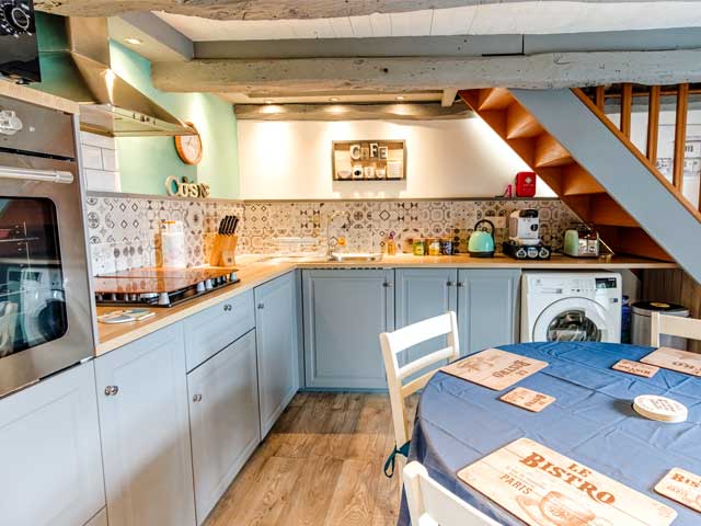 kitchen area with light grey cupboard doors and round kitchen table