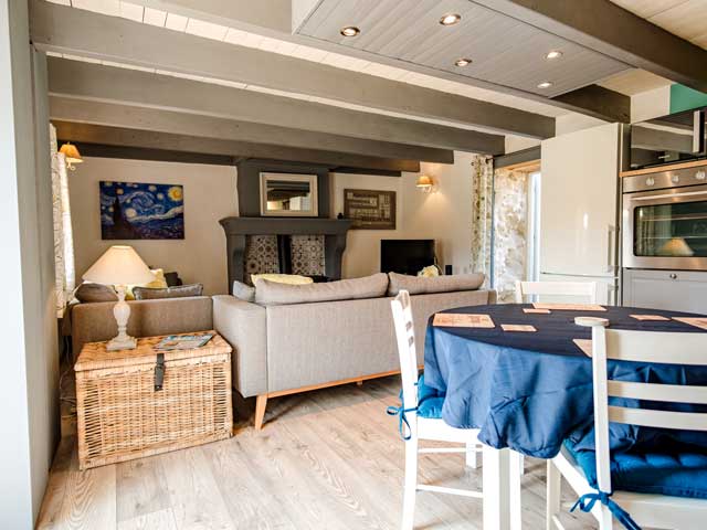 kitchen area looking across to the lounge area with comfortable sofas and television