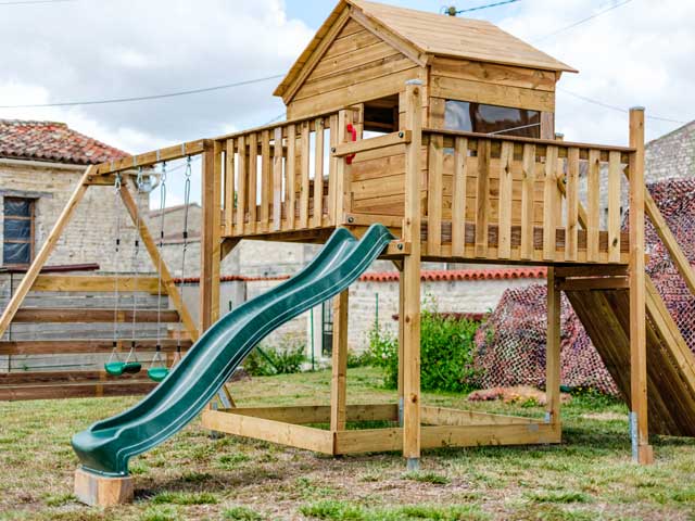 playground area with wooden structure for children to play on