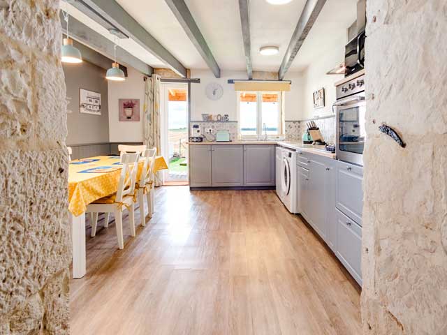 photo looking through the doorway into the well equipped holiday kitchen