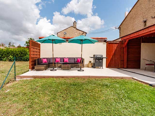Garden space with hard standing, bbq, comfortable summer seating and a shady area with dining table