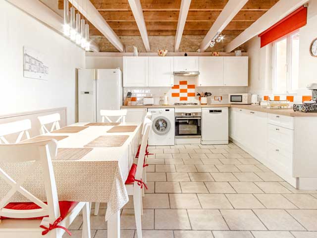 large white kitchen with dining table and six chairs